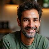 Dario Giannini smiling with coffee cup